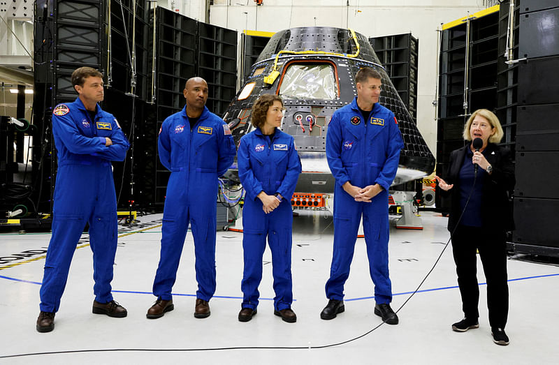 Astronauts for NASA's Artemis II mission stand in front of their Orion crew capsule, expected to carry Reid Wiseman, commander, Victor Glover, pilot, and mission specialists Christina Hammock Koch and Jeremy Hansen, with the Canadian Space Agency, as NASA Deputy Administrator Pam Melroy speaks at a press conference at the Kennedy Space Center in Cape Canaveral, Florida, US, 8 August, 2023.