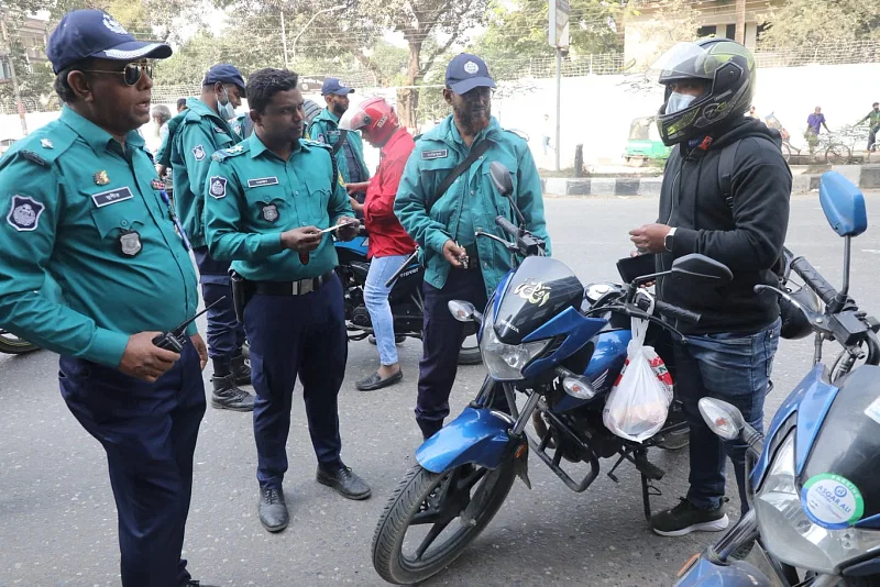 In this file photo, the policemen checking documents of a motorcycle