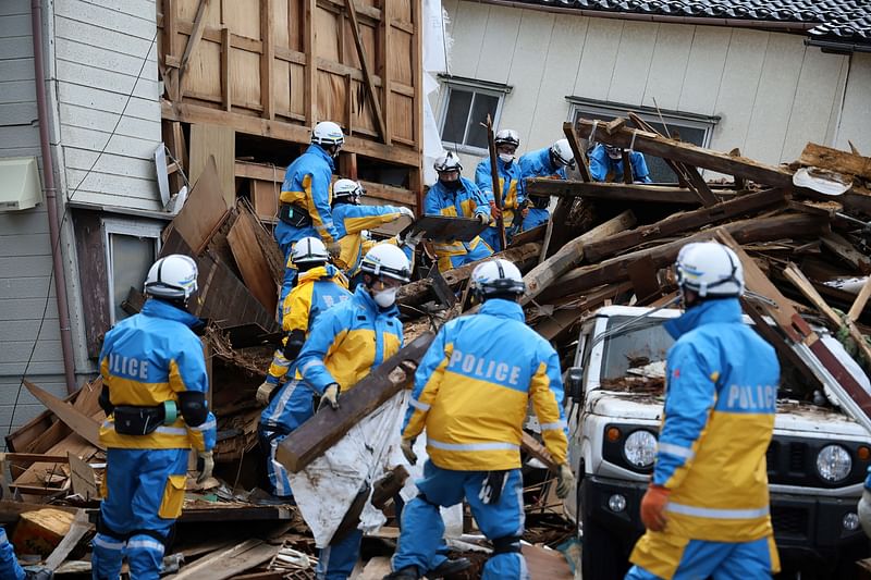 Police search for people in the rubble of a collapsed building in the city of Wajima, Ishikawa prefecture on 4 January, 2024, after a major 7.5 magnitude earthquake struck the Noto region in Ishikawa prefecture on New Year’s Day