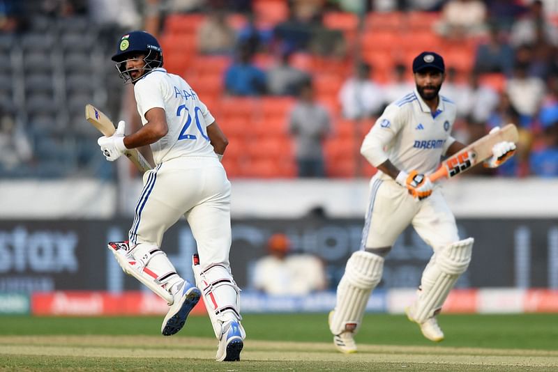 India’s Axar Patel (L) and Ravindra Jadeja run between the wickets during the second day of the first Test cricket match between India and England at the Rajiv Gandhi International Stadium in Hyderabad on 26 January, 2024