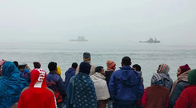 People look at the drowning ferry