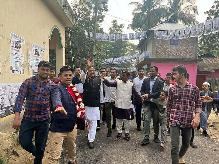 Garlanded Jasim Uddin, currently serving as the Deputy Commissioner (Development) at the Dhaka Metropolitan Police Headquarters, is seen in the electoral campaign of boat candidate in Feni-2 constituency