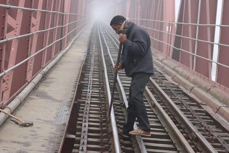 A railway worker is checking the railway line early in the morning. Photo taken from Teesta Railway Bridge in Kaunia, Rangpur on 9 January.