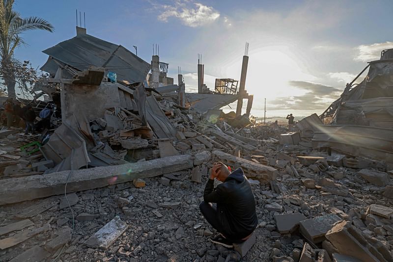 A man sits amid the debris of destroyed houses in the aftermath of Israeli bombardment in Rafah in the southern Gaza Strip on 22 February, 2024, amid continuing battles between Israel and the Palestinian militant group Hamas