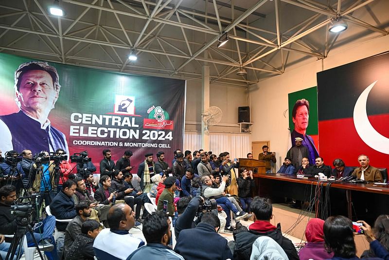 Former prime minister Imran Khan's Pakistan Tehreek-e-Insaf (PTI) party nominee for prime minister, Omar Ayub Khan (R) speaks during a press conference at PTI's central secretariat in Islamabad on February 18, 2024