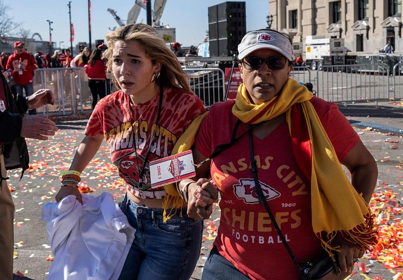 People flee after shots were fired near the Kansas City Chiefs' Super Bowl LVIII victory parade on 14 February 2024, in Kansas City, Missouri.