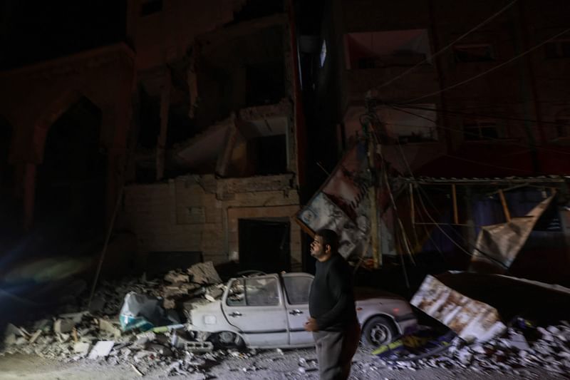 A man walks past a destroyed building following Israeli bombardments over Rafah in the southern Gaza Strip on February 12, 2024 amid the ongoing conflict between Israel and the Palestinian Hamas