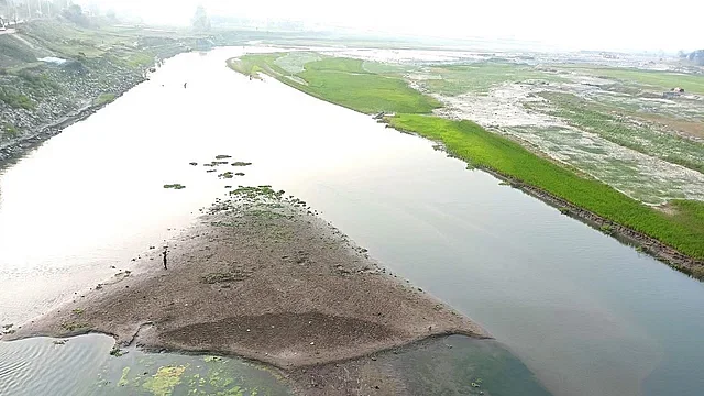 Despite carrying out dredging, chars (shoals) are emerging in different areas of the old Bhramaputra river and knee-deep water in most of the places in Jamalpur. The photo was taken from the old ferry ghat area of Jamalpur town on Sunday afternoon.