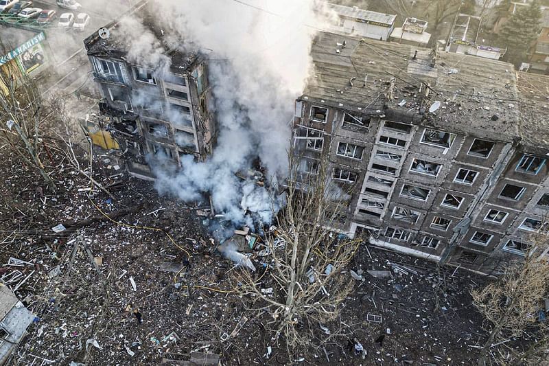 This handout photograph taken and released by National Police of Ukraine on February 14, 2024, shows rescuers extinguish a fire in a residential building following a missile attack in Selydove, Donetsk region, amid the Russian invasion of Ukraine