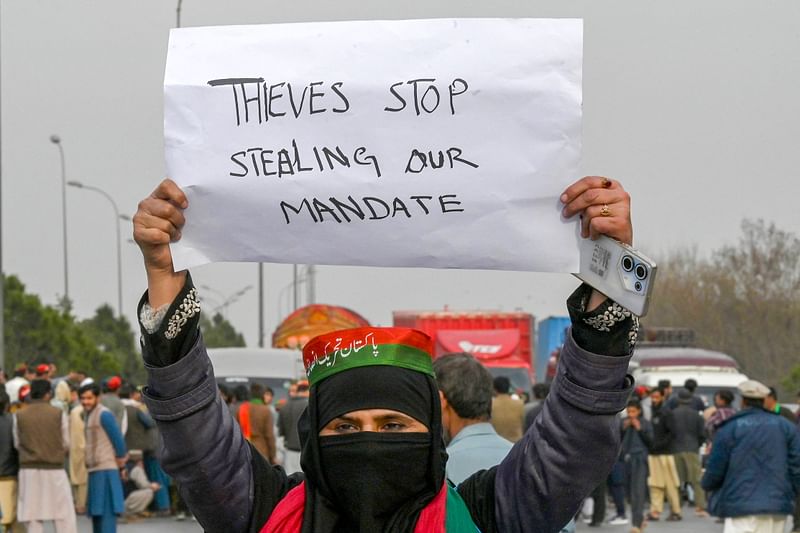 Supporters of Khan's Pakistan Tehreek-e-Insaf (PTI) party block Peshawar to Islambad highway as they protest against the alleged skewing in Pakistan's national election results, in Peshawar on 12 February, 2024