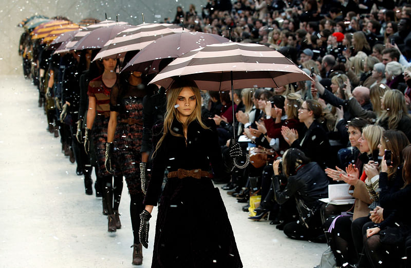 Model Cara Delevingne (C) presents a creation at the Burberry Prorsum 2012 Autumn/Winter collection show during London Fashion Week 20 February, 2012.