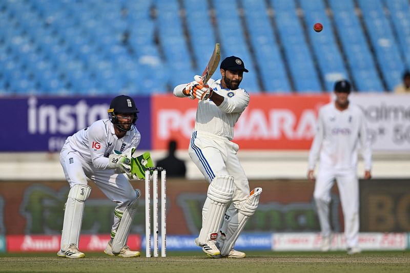 India's Ravindra Jadeja (C) plays a shot during the first day of the third Test cricket match between India and England at Niranjan Shah stadium in Rajkot on February 15, 2024.