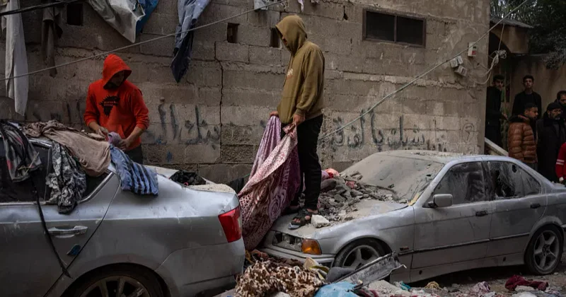 Palestinians look at the destruction after an Israeli airstrike in Rafah, Gaza Strip, Friday, on 9 February, 2024.