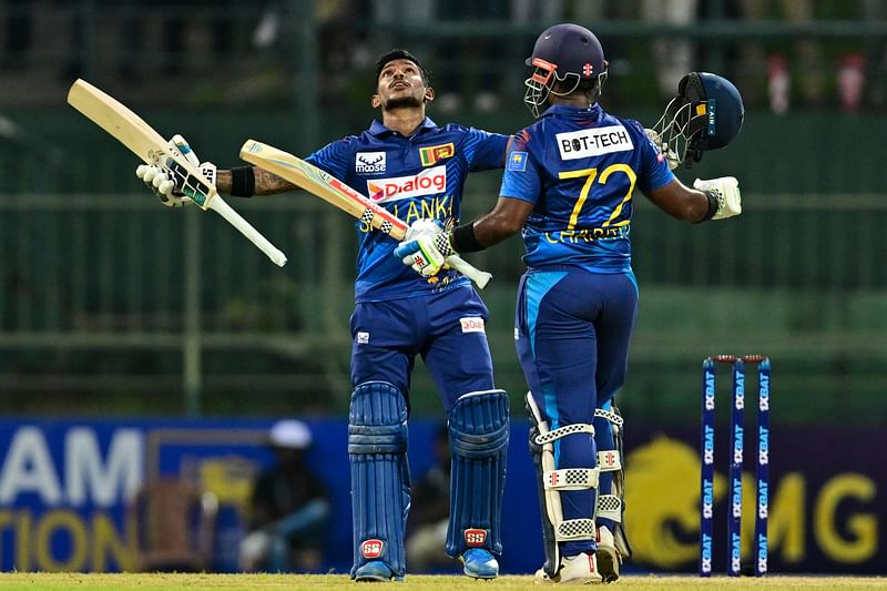 Sri Lanka's Pathum Nissanka (L) celebrates after scoring a double century (200 runs) as Charith Asalanka during the first one-day international (ODI) cricket match between Sri Lanka and Afghanistan at the Pallekele International Cricket Stadium in Kandy on 9 February 2024.