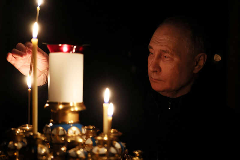 Russian President Vladimir Putin lights a candle in memory of the victims of the Crocus City Hall attack, on the day of national mourning in a church at the Novo-Ogaryovo state residence outside Moscow, Russia on 24 March, 2024