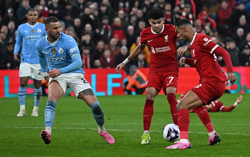 Liverpool's Colombian midfielder #07 Luis Diaz (C) and Liverpool's Dutch striker #18 Cody Gakpo (R) appear to get in each others way during the English Premier League football match between Liverpool and Manchester City at Anfield in Liverpool, north west England on March 10, 2024