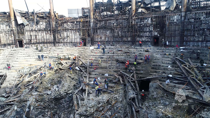 Members of the Russian Emergencies Ministry and workers remove debris inside the burnt-out Crocus City Hall following a deadly attack on the concert venue outside Moscow, Russia, in this still image taken from video released on 26 March, 2024