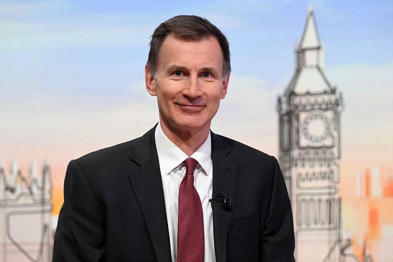 A handout picture released by the BBC, taken and received on 24 March, 2024, shows Britain's Chancellor of the Exchequer Jeremy Hunt appearing on the BBC's 'Sunday Morning' political television show with journalist Laura Kuenssberg