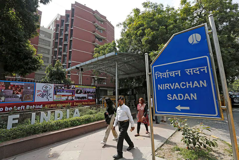 People walk past the Election Commission of India office building in New Delhi, India 11 March, 2019.