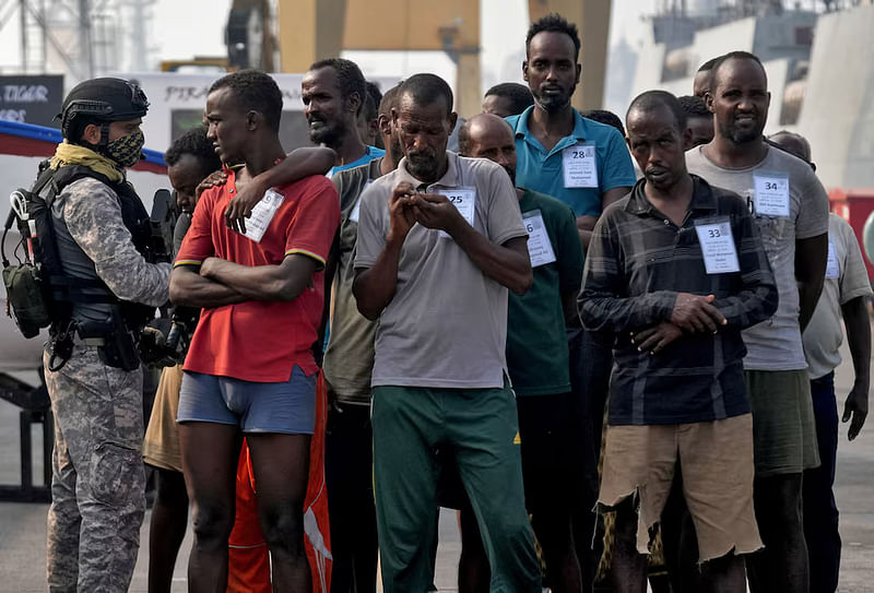 An Indian soldier stands guard next to captured Somali pirates after they were brought in for prosecution by the Indian Navy, at the Naval Dockyard in Mumbai, India, on 23 March, 2024.