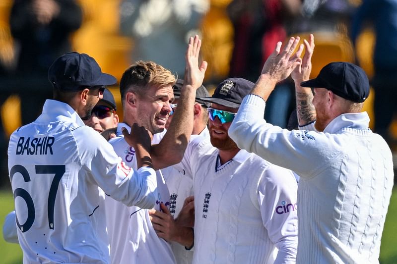 England's James Anderson (C) celebrates with teammates after taking the wicket of India's Kuldeep Yadav during the third day of the fifth and last Test cricket match between India and England at the Himachal Pradesh Cricket Association Stadium in Dharamsala on 9 March 2024.