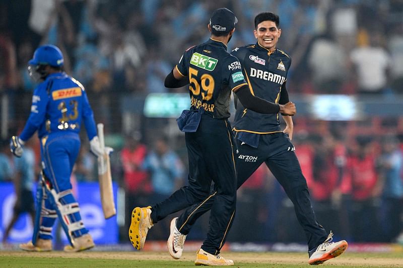 Gujarat Titans' captain Shubman Gill (R) celebrates with his teammate after winning the Indian Premier League (IPL) Twenty20 cricket match between Gujarat Titans and Mumbai Indians at the Narendra Modi Stadium in Ahmedabad on March 24, 2024