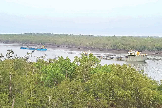 Vessels carrying industrial raw materials from India travel through the Sundarbans down the Bojboja river from Angtihara customs station in Koyra. The photo wsa taken on Wednesday afternoon at Bojboja in Koyra