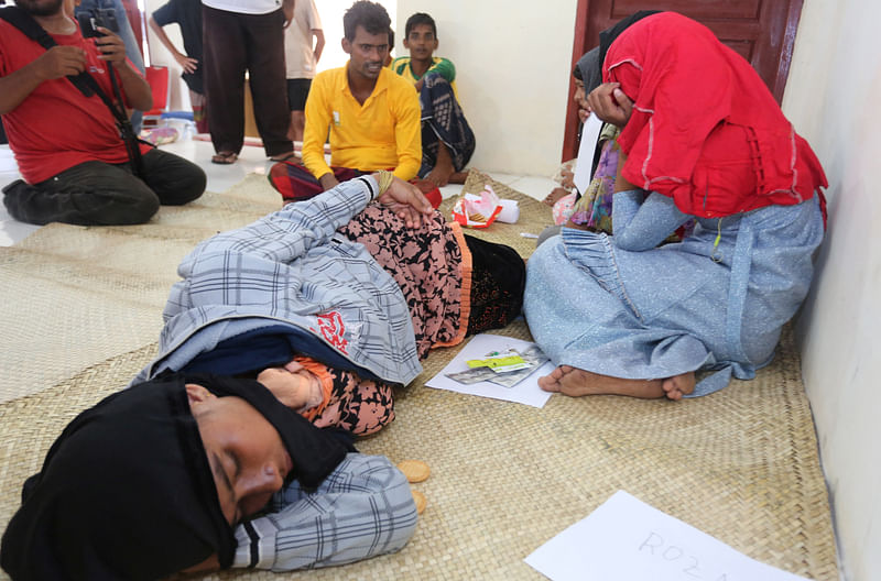 Rohingya Muslim refugees rest at the Samatiga District Office after Indonesian fishermen rescued dozens of Rohingya after high tides capsized their boat in waters off the West Aceh, in Aceh province, Indonesia, on 20 March, 2024, in this photo taken by Antara Foto