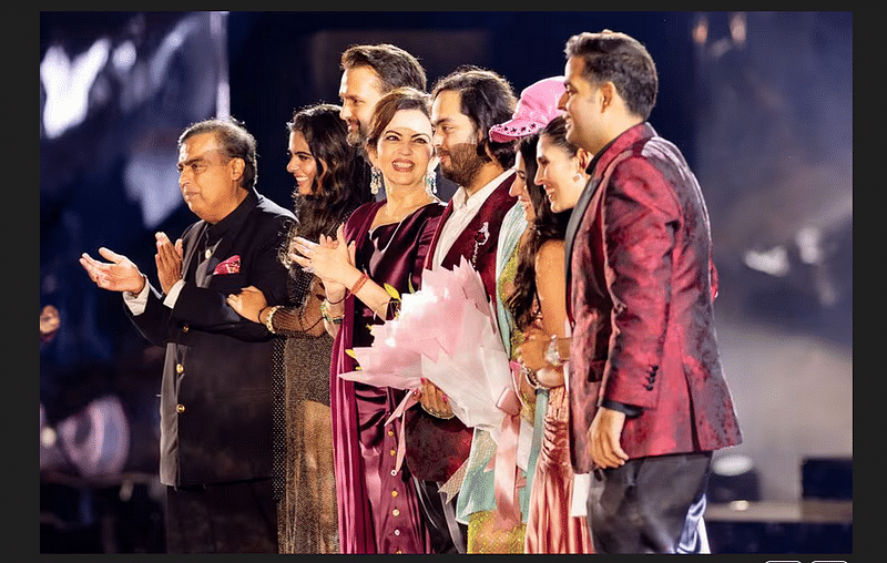 Mukesh Ambani, the Chairman of Reliance Industries, Isha Piramal, Anand Piramal, Nita Ambani, Anant Ambani, Rihanna, Radhika Merchant, Shloka Mehta Ambani and Akash Ambani stand on the stage during pre-wedding celebrations