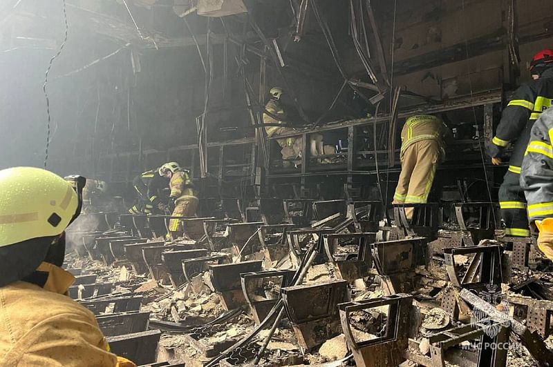 This handout photograph taken and released by Russian Emergency Ministry on 23 March 2024 shows rescuers working inside the Crocus City Hall, a day after a gun attack in Krasnogorsk, outside Moscow.