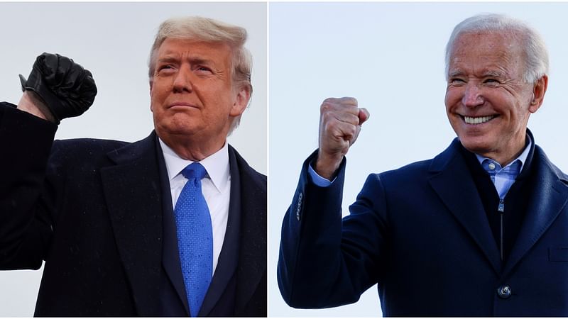 A combination picture shows US president Donald Trump pumping his fist during a campaign event at Capital Region International Airport in Lansing, Michigan, US on 27 October 2020, and Democratic US presidential nominee and former vice president Joe Biden making a fist during a drive-in campaign stop in Des Moines, Iowa, US, on 30 October 2020