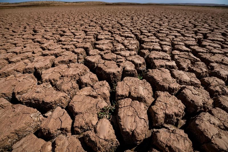 This picture taken on 6 March, 2024, shows cracked earth at al-Massira dam in Ouled Essi Masseoud village, some 140 kilometres (85 miles) south of Casablanca.