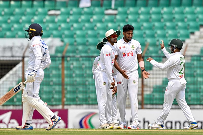 Bangladesh’s Khaled Ahmed (2R) celebrates with teammates after taking the wicket of Sri Lanka’s captain Dhananjaya de Silva (L) during the second day of the second Test cricket match between Bangladesh and Sri Lanka at the Zahur Ahmed Chowdhury Stadium in Chittagong on 31 March, 2024