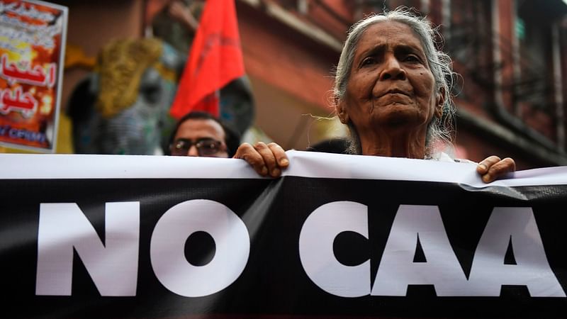 Activist of left parties stand behing a banner during a protest against India`s new citizenship in Kolkata on 26 February 2020, following clashes between people supporting and opposing a contentious amendment to India`s citizenship law in New Delhi