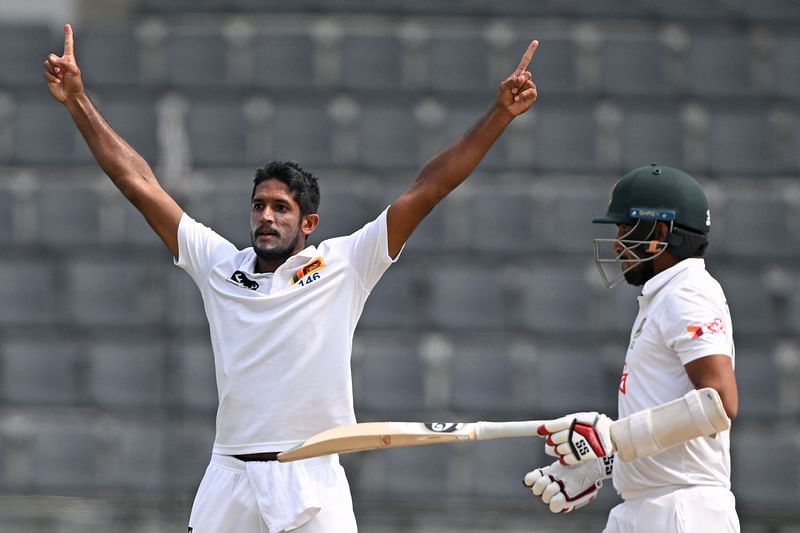 Sri Lanka's Kasun Rajitha (L) celebrates after taking the wicket of Bangladesh's Khaled Ahmed during the fourth day of the first Test cricket match between Bangladesh and Sri Lanka at the Sylhet International Cricket Stadium in Sylhet on 25 March, 2024.