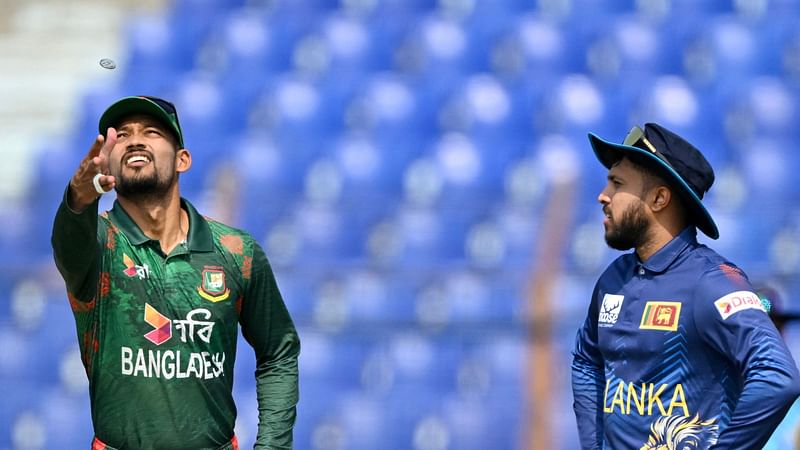 Sri Lanka’s captain Kusal Mendis (R) looks on as Bangladesh’s captain Najmul Hossain Shanto (R) tosses a coin prior to the start of the second One Day International cricket match between Bangladesh and Sri Lanka at the Zahur Ahmed Chowdhury Stadium in Chittagong on 15 March, 2024