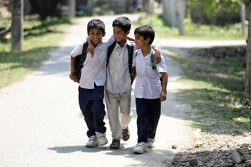 Three children returning home from school