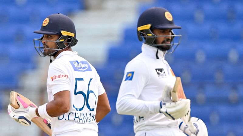 Sri Lanka’s captain Dhananjaya de Silva (R) and Dinesh Chandimal run between the wickets during the second day of the second Test cricket match between Bangladesh and Sri Lanka at the Zahur Ahmed Chowdhury Stadium in Chittagong on 31 March, 2024