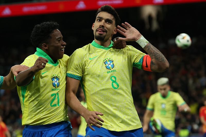 Brazil’s midfielder #08 Lucas Paqueta (R) celebrates scoring his team’s third goal during the international friendly football match between Spain and Brazil at the Santiago Bernabeu stadium in Madrid on 26 March, 2024