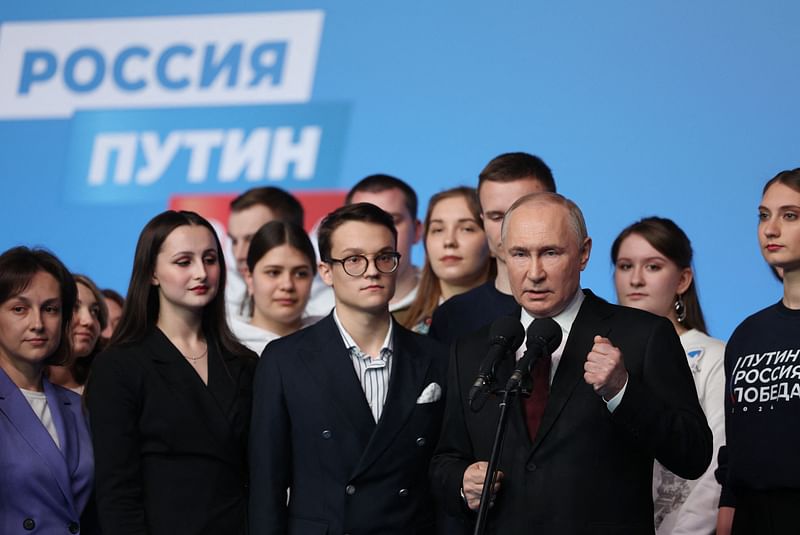 In this pool photograph distributed by Russia's state agency Sputnik, Russian President Vladimir Putin meets with his confidants and volunteers of his campaign headquarters in Moscow on March 17, 2024