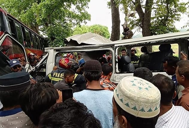 People look at the damaged microbus