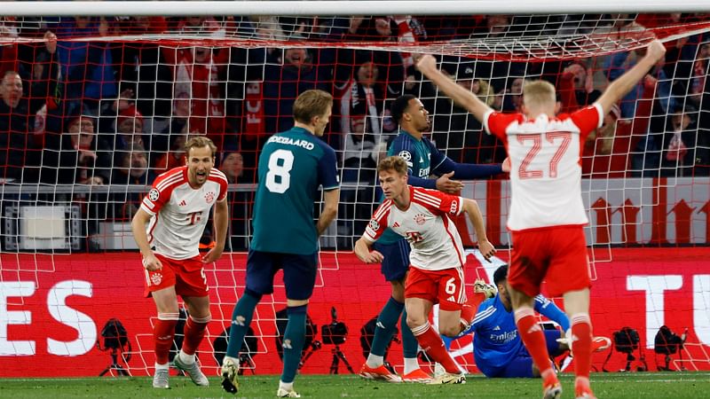 Bayern Munich's German midfielder #06 Joshua Kimmich (3L) celebrates scoring the opening goal with team mates Bayern Munich's English forward #09 Harry Kane (L) and Bayern Munich's Austrian midfielder #27 Konrad Laimer (R) during the UEFA Champions League quarter-final second leg football match between FC Bayern Munich and Arsenal FC in Munich, southern Germany on 17 April, 2024