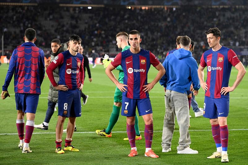 Barcelona’s Spanish midfielder #08 Pedri, Barcelona’s Spanish forward #07 Ferran Torres and Barcelona’s Polish forward #09 Robert Lewandowski react at the end of the UEFA Champions League quarter-final second leg football match between FC Barcelona and Paris SG at the Estadi Olimpic Lluis Companys in Barcelona on 16 April, 2024