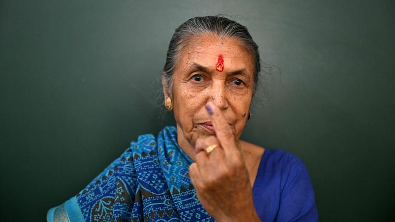 woman shows inked finger after casting her ballot at a polling station during the second phase of voting of India's general elections in Ghaziabad on 26 April, 2024