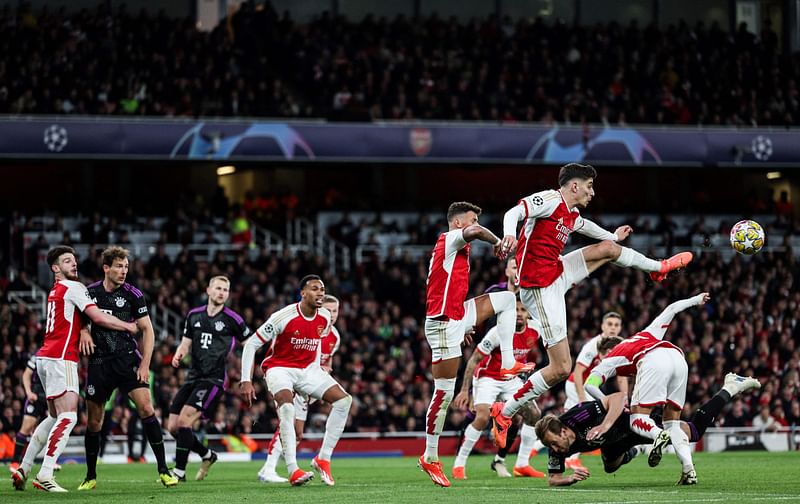 Arsenal's German midfielder #29 Kai Havertz (up R) jumps to clear the ball during the UEFA Champions League quarter final first-leg football match between Arsenal and Bayern Munich at the Arsenal Stadium, in north London, on April 9, 2024.