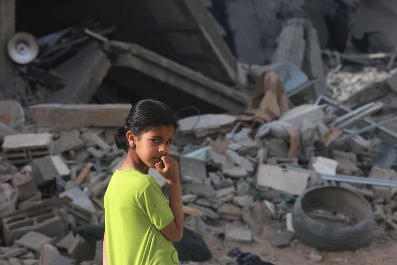 A girl looks at the rubble of a building destroyed in overnight Israeli bombardment in Rafah in the southern Gaza Strip, on 25 April, 2024 amid the ongoing conflict between Israel and the Palestinian militant group Hamas