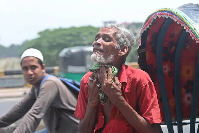 An old man sweats due to schorching heat. The picture was take from Chattogram city.