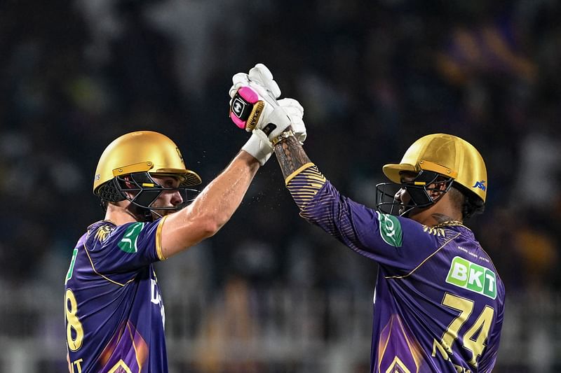 Kolkata Knight Riders' Phil Salt (L) is congratulated by Sunil Narine after scoring a half-century (50 runs) during the Indian Premier League (IPL) Twenty20 cricket match between Kolkata Knight Riders and Delhi Capitals at the Eden Gardens in Kolkata on April 29, 2024