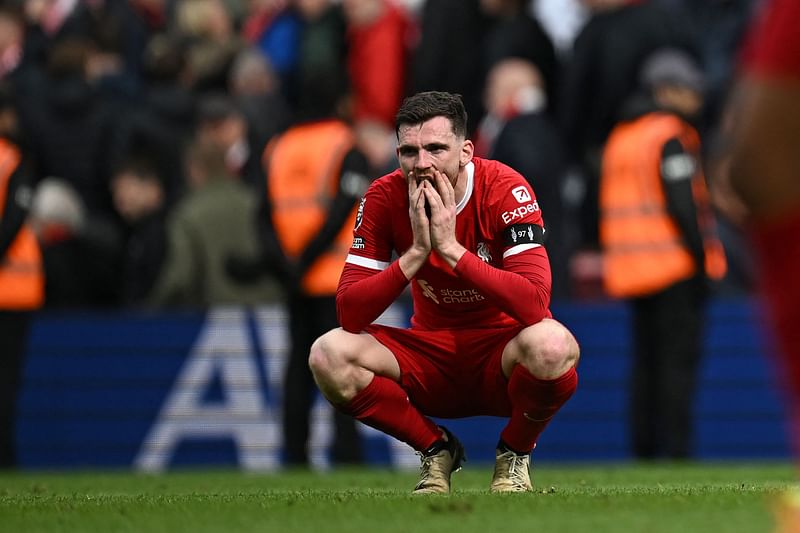 Liverpool's Scottish defender #26 Andrew Robertson reacts to their defeat on the pitch after the English Premier League football match between Liverpool and Crystal Palace at Anfield in Liverpool, north west England on April 14, 2024. Palace won the game 1-0