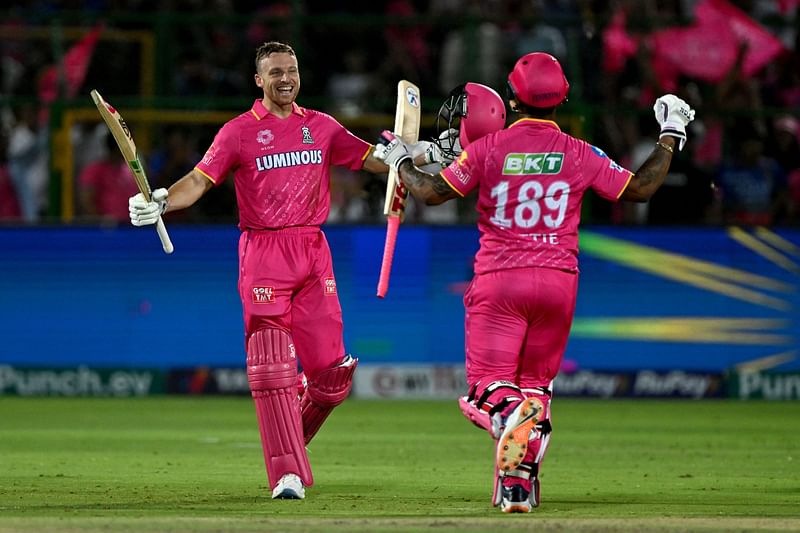 Rajasthan Royals' Jos Buttler (L) and Shimron Hetmyer celebrate after their win against Royal Challengers Bengaluru at the Indian Premier League (IPL) Twenty20 cricket match in Sawai Mansingh Stadium of Jaipur on April 6, 2024